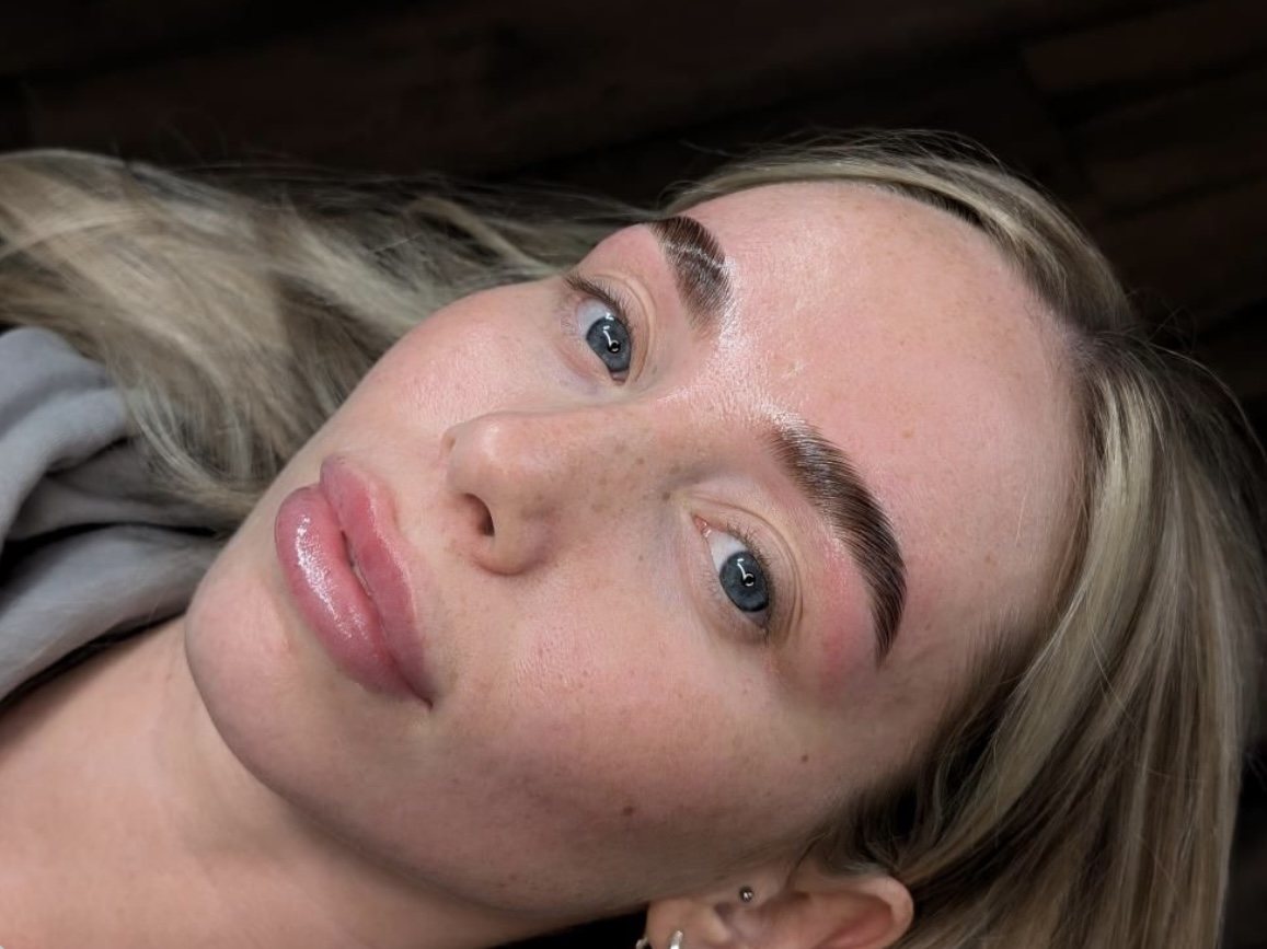 A client lying back with freshly finished brows