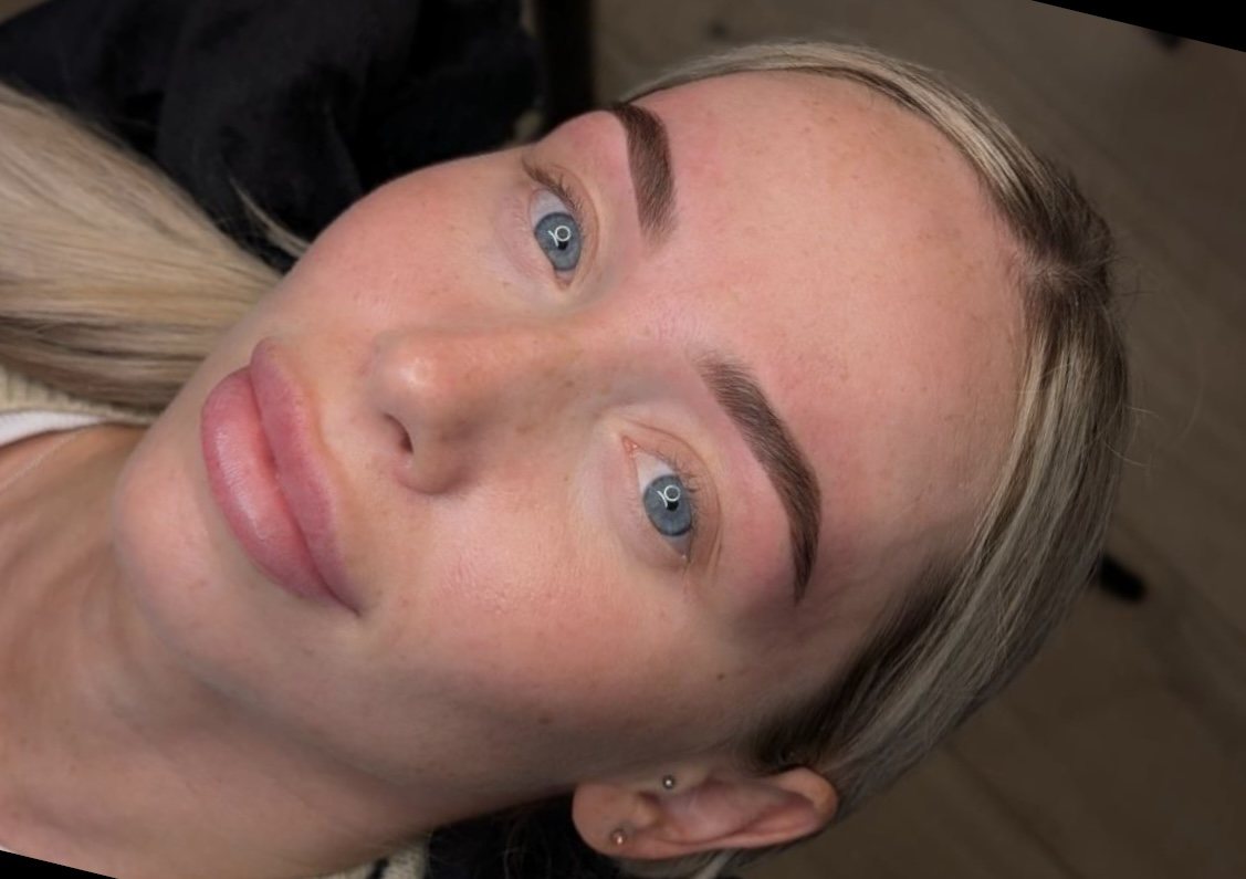 A client lying back with finished brows