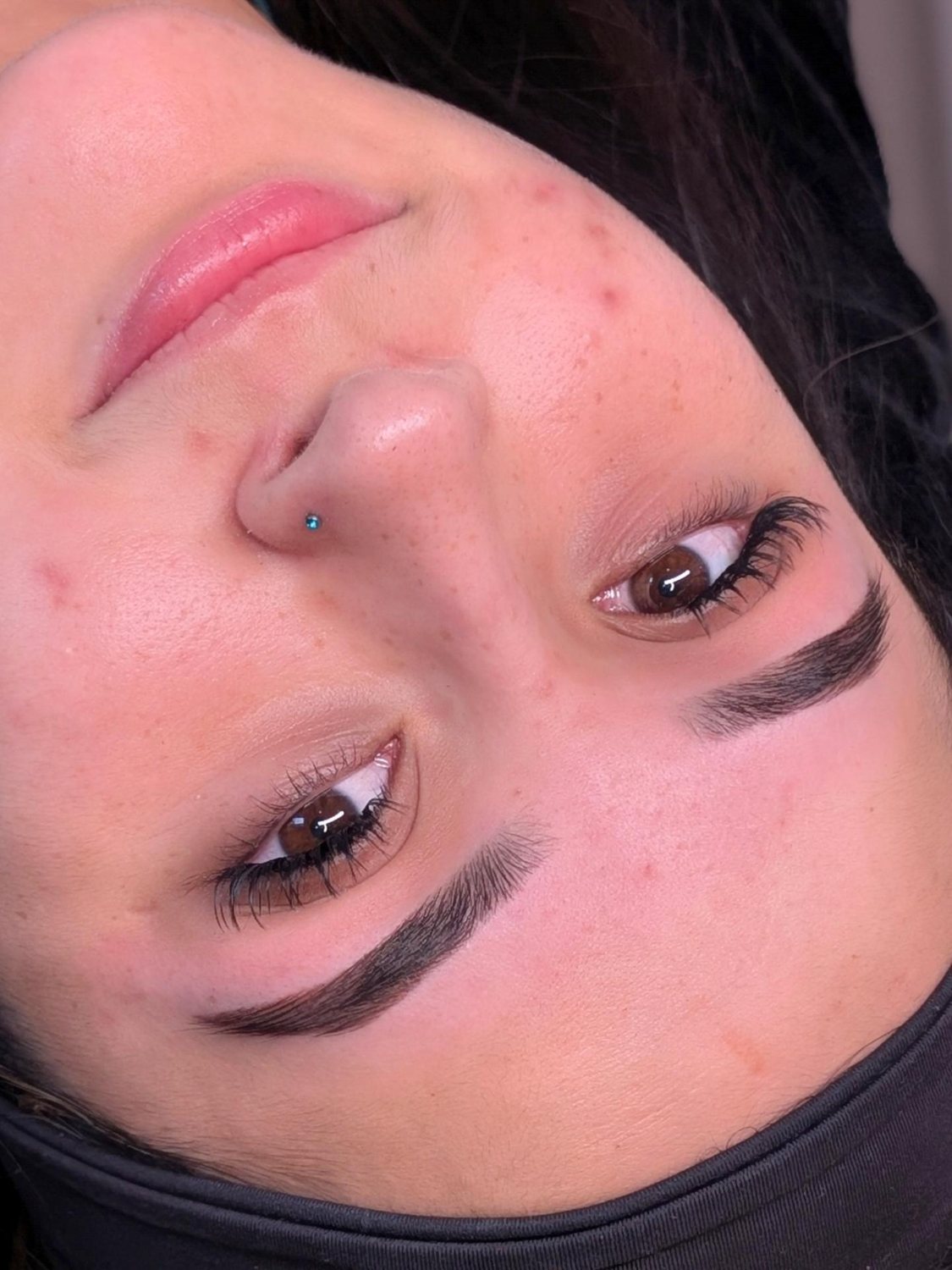 Dark laminated brows on a client lying back